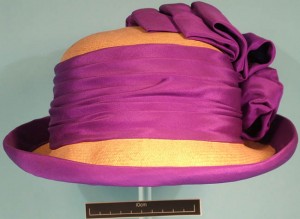 Cloche straw hat with purple silk ribbon decoaration.