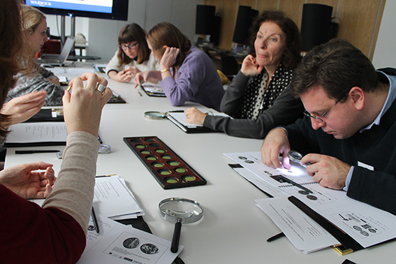 Teachers handling Greek coins from the Ashmolean collection